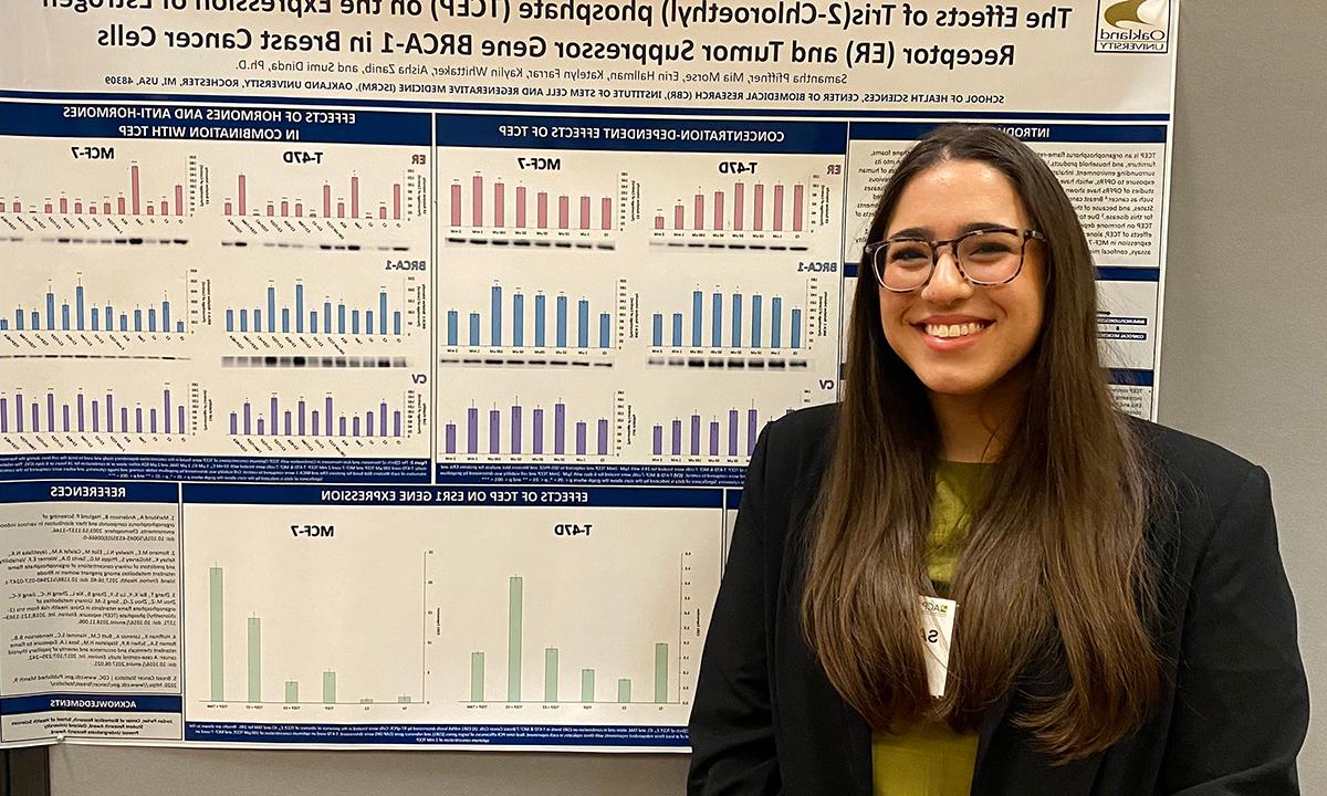 Samantha Pfiffner stands in front of her research poster