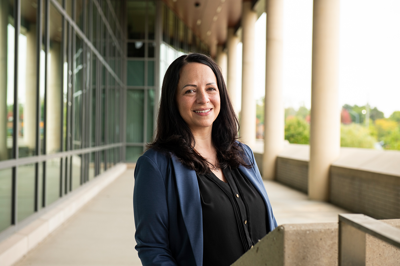 Sara Rivard proudly smiles outside of the Human Health Building