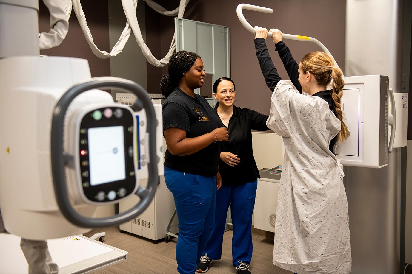 Sara Rivard demonstrates how to position a patient for an x-ray