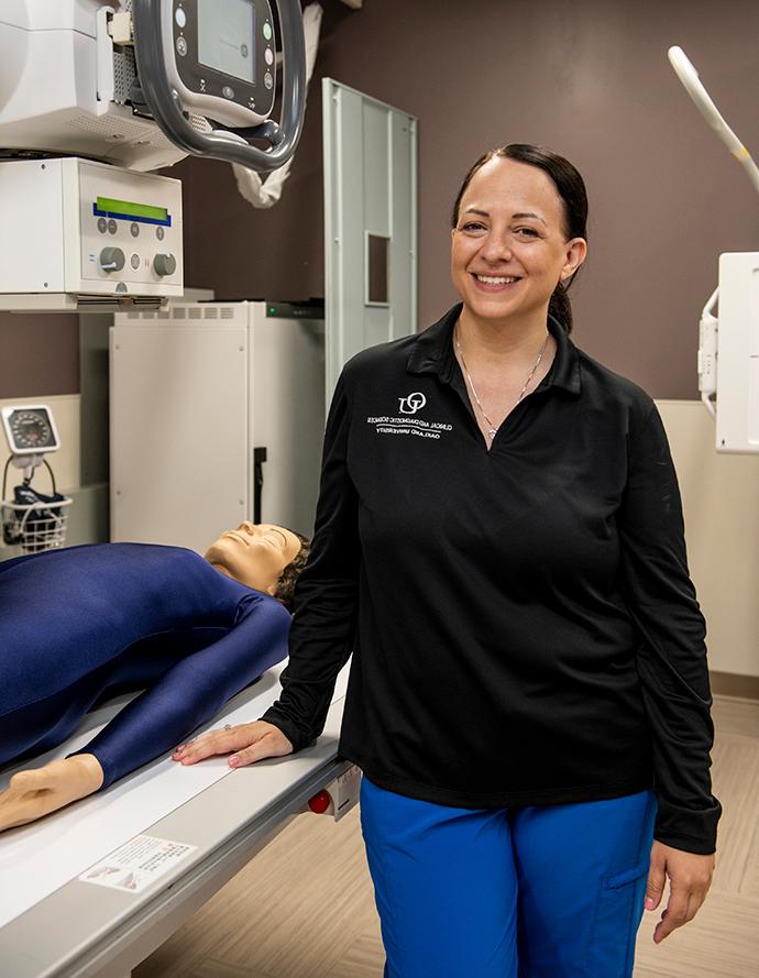 Sara Rivard in an x-ray lab smiling confidently