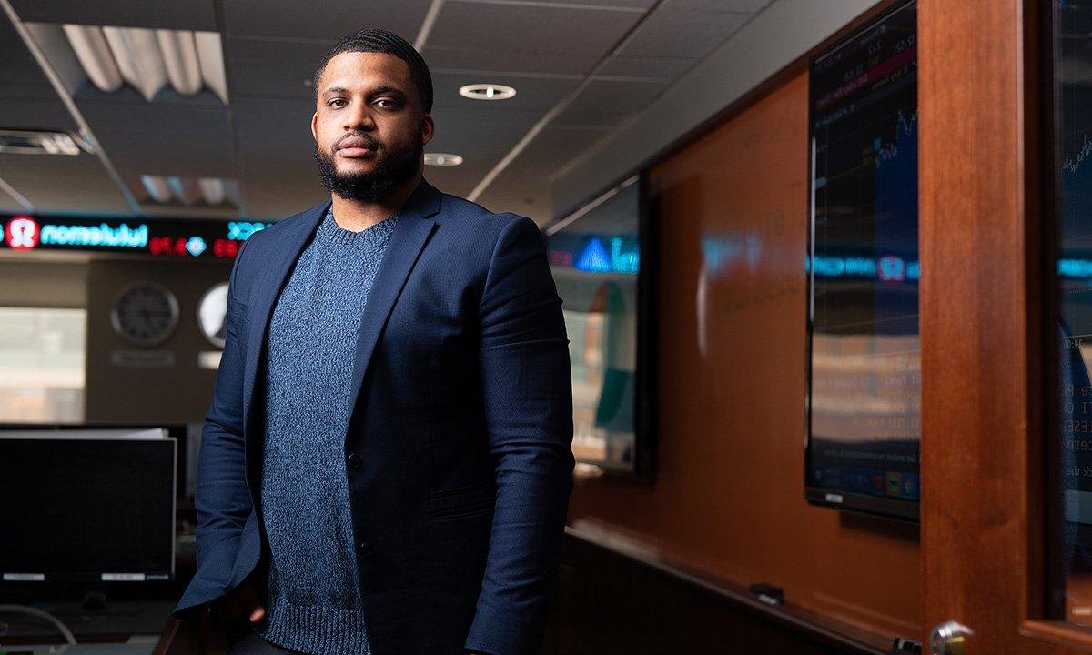 Black male standing in computer lab.