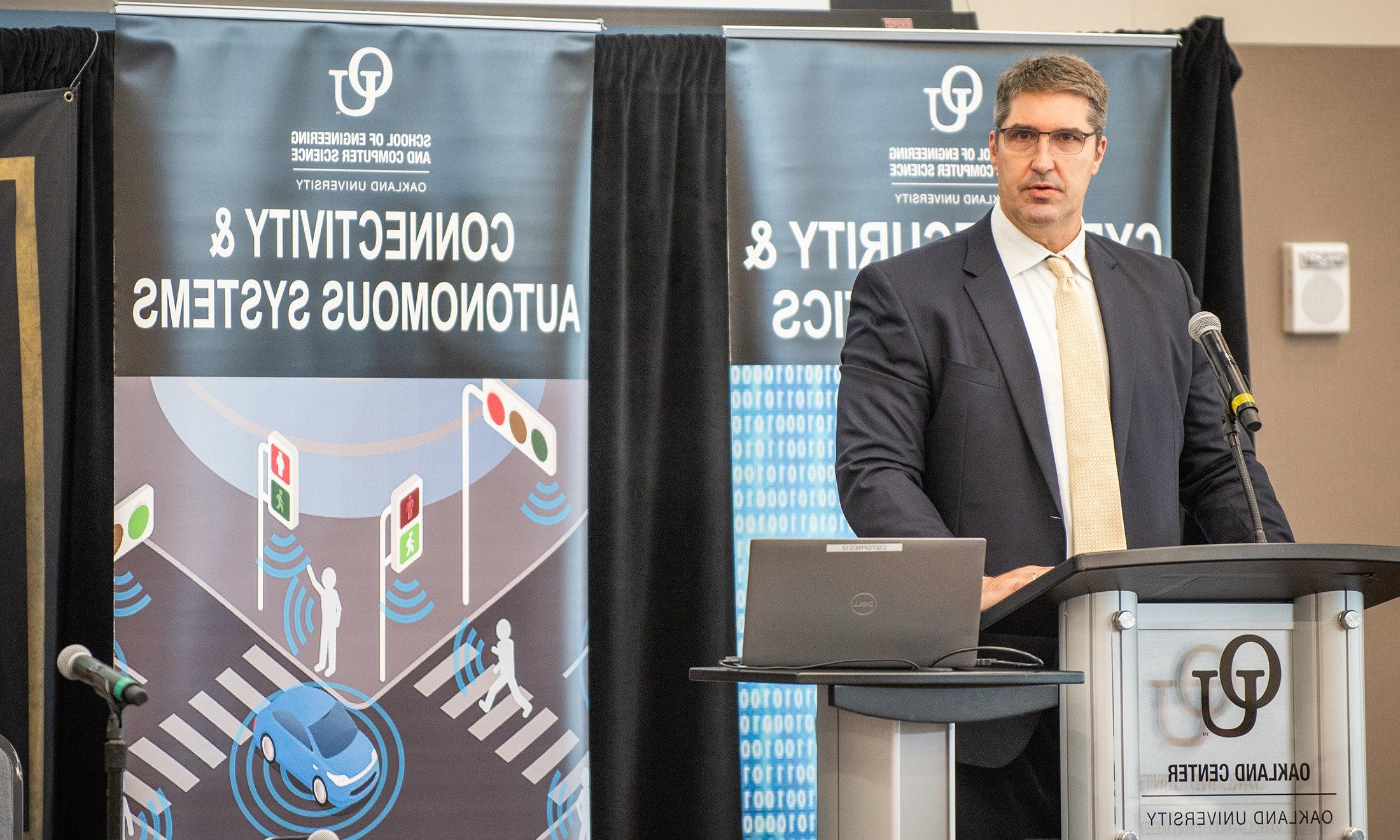 A man speaking at a podium