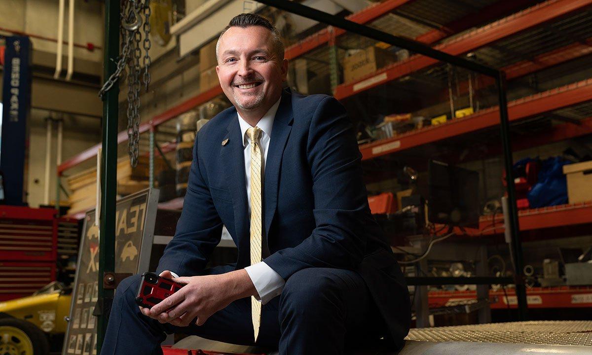 Man sitting on bench in warehouse