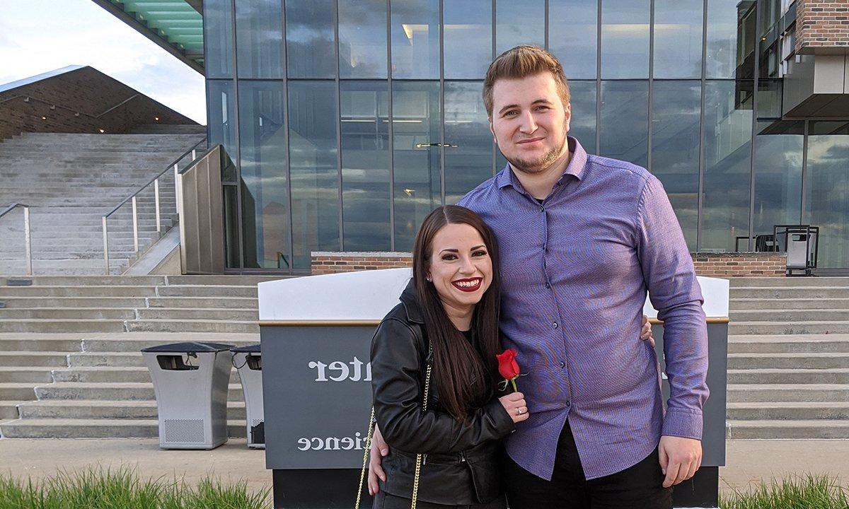 The engaged couple in front of the Engineering Center