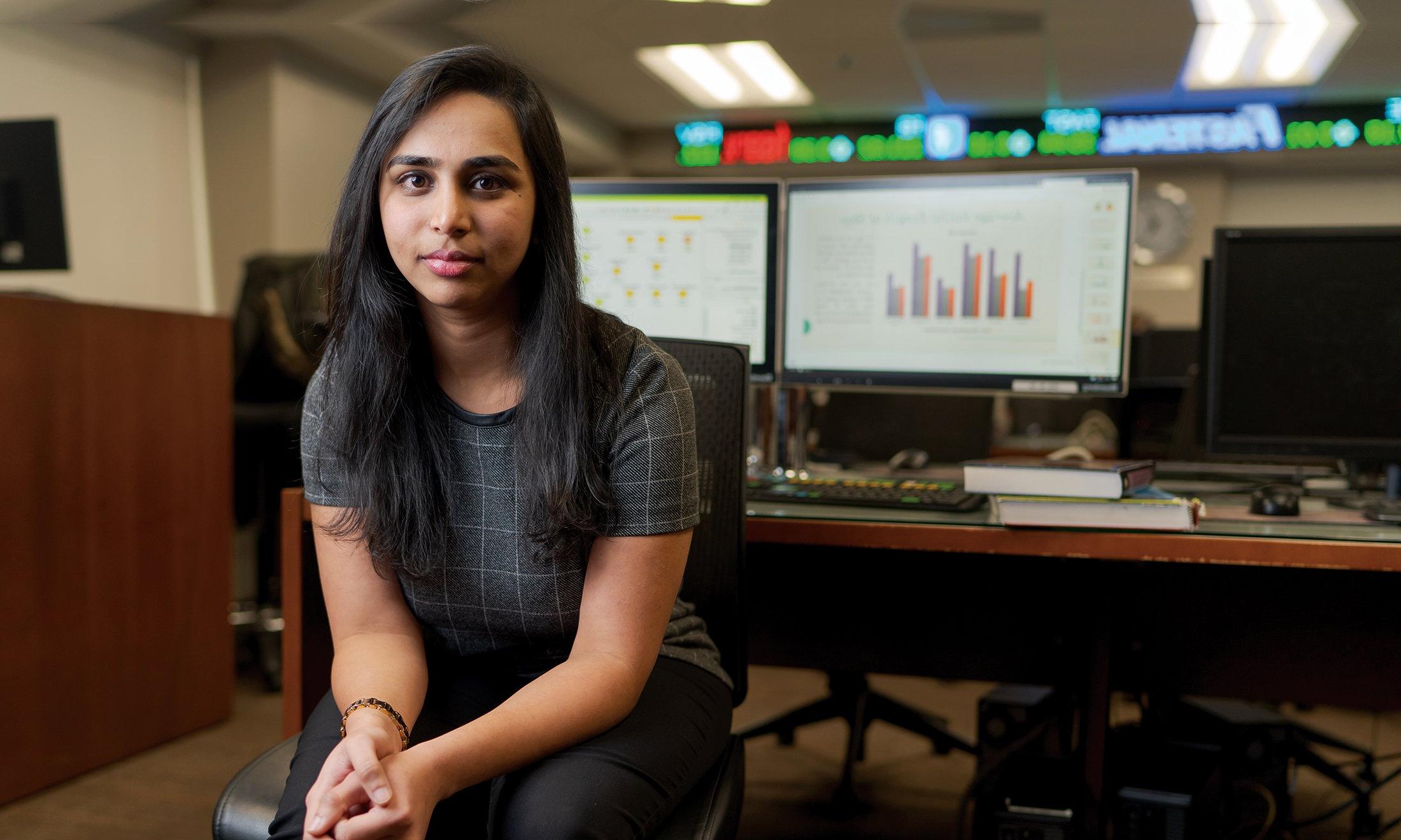 A woman sitting in front of computers. 