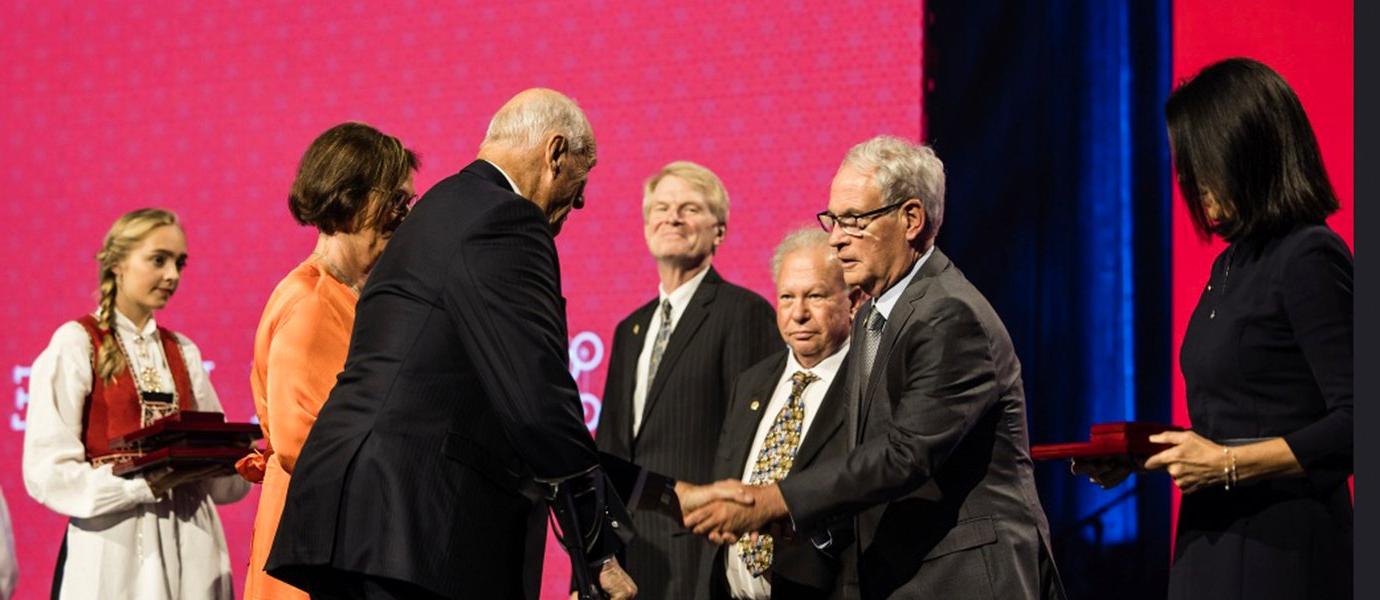 People receiving awards on stage