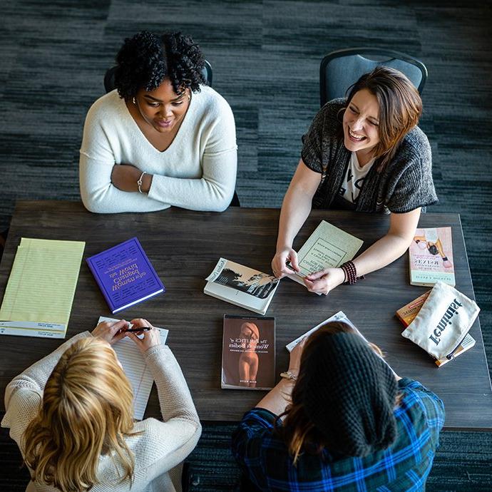 4 women sitting at table