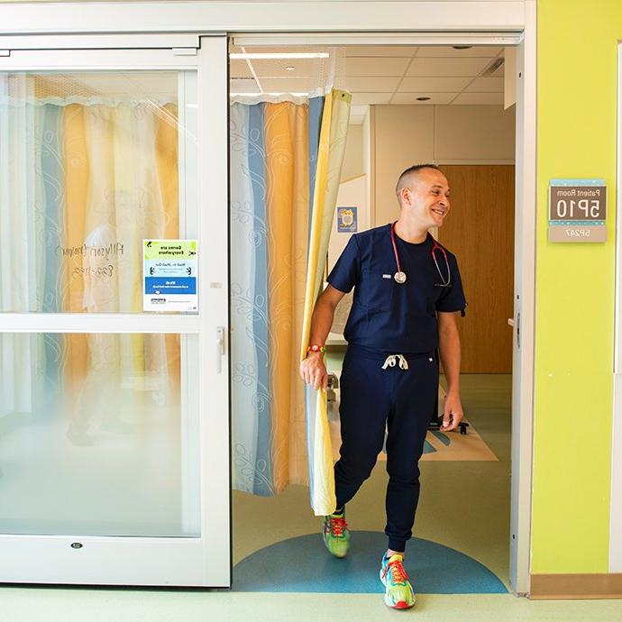 Man walking out of hospital room